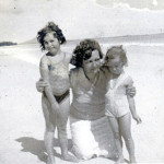 woman with two small children on the beach