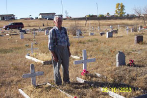 Max Ebel at North Dakota grave of native American child he and fellow internee railroaders tried to save