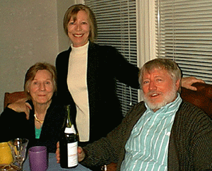 the family poses at a table, smiling