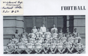 high school football players, in numbered jerseys, lined up on stairs