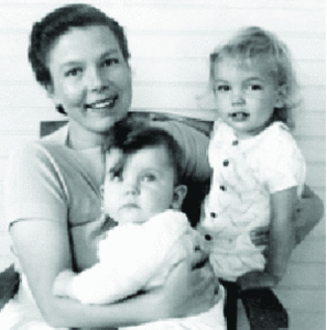photo: Starr is smiling, holding dark-haired Ingrid in her lap, and blonde Heidi next to her