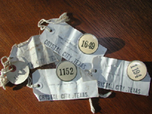 image of baggage tags, with numbers, names, and destinations, to be worn by internees while traveling