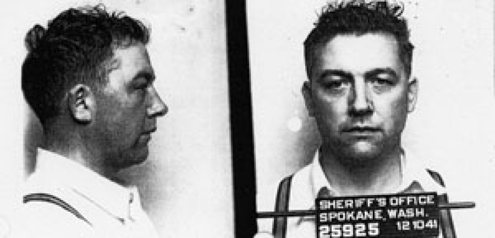 profile and head-on photos of Karl Vogt, with "Sheriff's Office, Spokane, Wash." and date on sign in front of him-standard "mug shot"