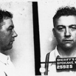 profile and head-on photos of Karl Vogt, with "Sheriff's Office, Spokane, Wash." and date on sign in front of him-standard "mug shot"