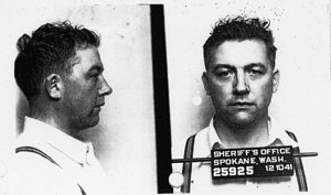 profile and head-on photos of Karl Vogt, with "Sheriff's Office, Spokane, Wash." and date on sign in front of him-standard "mug shot"