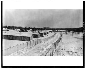 double chainlink fences along road and buildings-snow