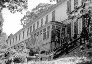 photo of exterior of barracks building, perched on a hill