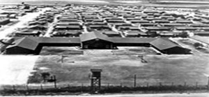 overview of Crystal City Internment Camp buildings with barbed wire fence and guard tower