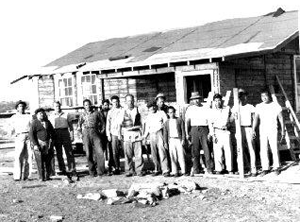 many men in front of incomplete bungalow