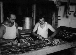 2 men preparing food in kitchen